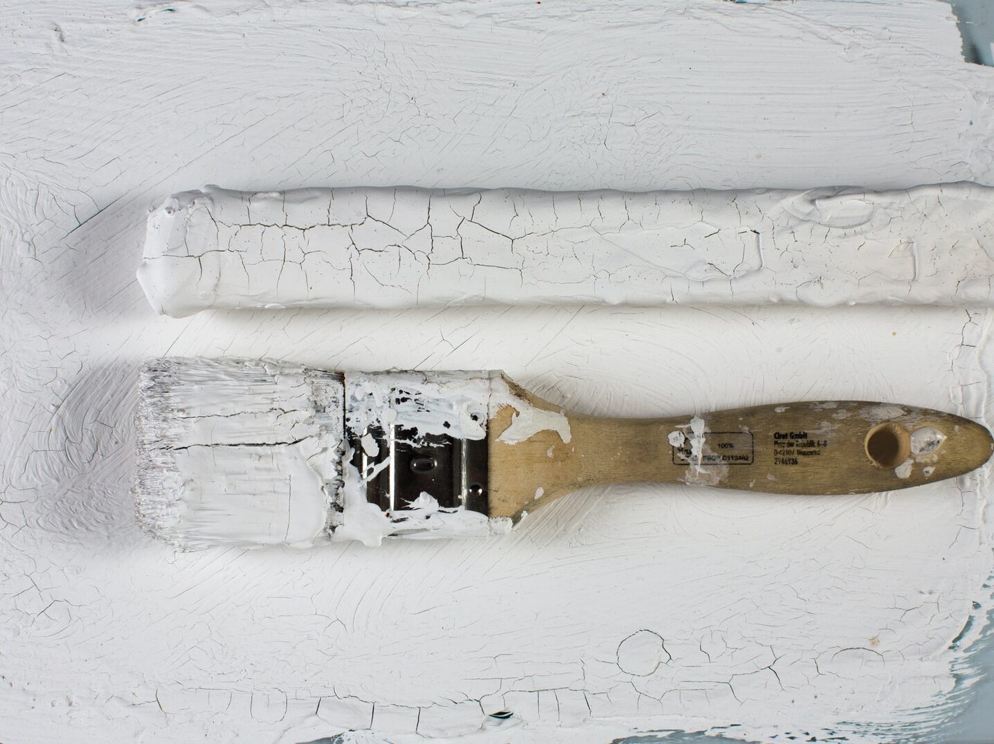 white paint brush on white wall