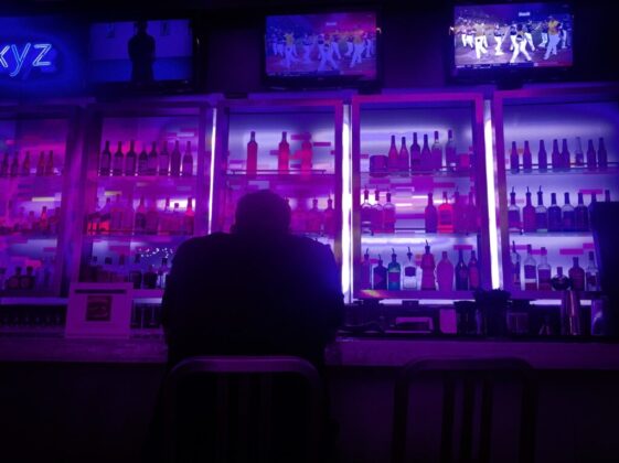 person sitting beside bar counter
