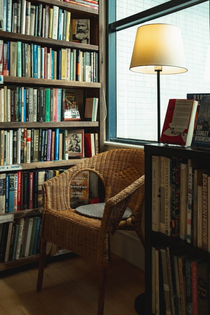 brown wicker chair and books