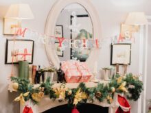 Merry Christmas letter banner hanging on sconces in white painted room