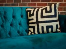 black and white throw pillow on blue couch