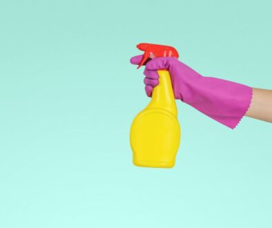 person holding yellow plastic spray bottle