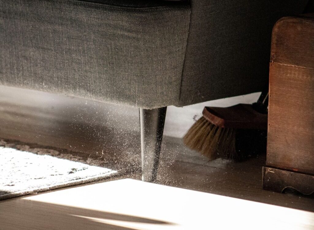 a close up of a chair with a broom on the floor