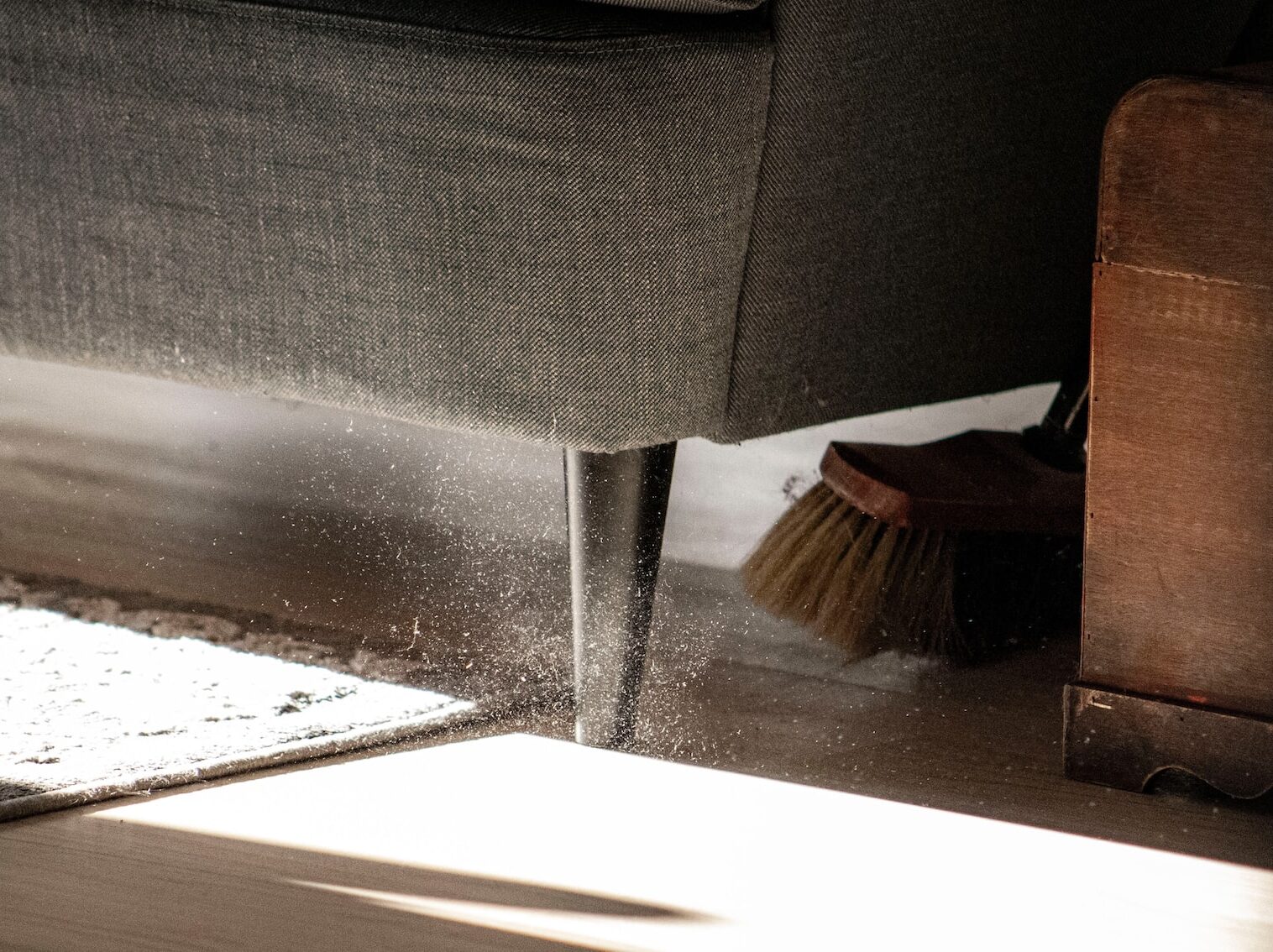 a close up of a chair with a broom on the floor