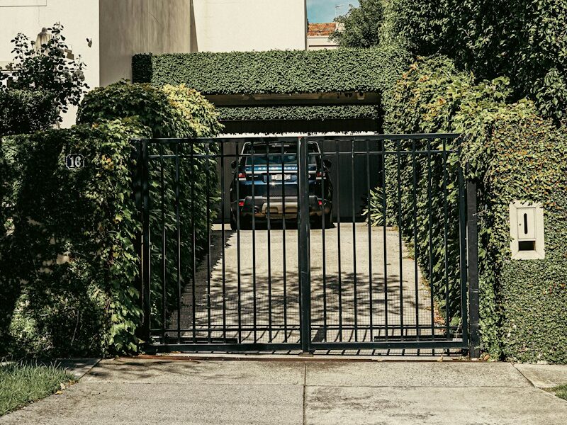 a car is parked in front of a gate